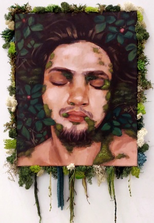 Acrylic portrait of myself with my eyes closed, laying on the ground in wild strawberries. There is moss growing on me, and glued to the border of the canvass.