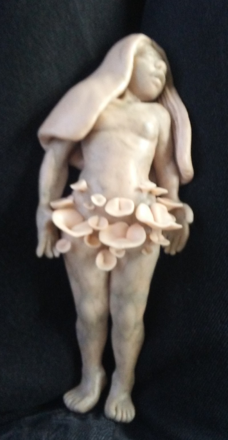 the previous sculpture without paint. it is pale peach colored