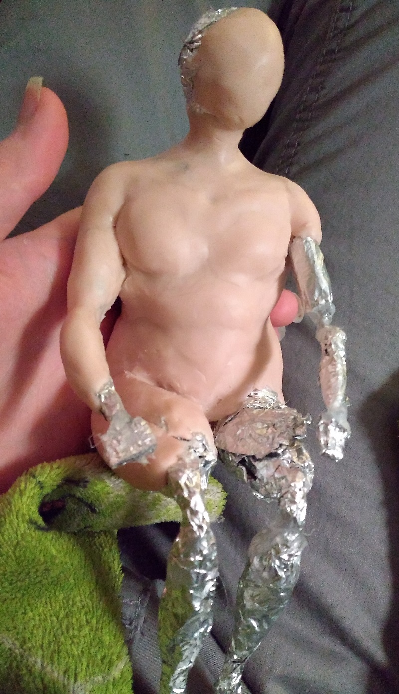 a rough tin foil base partially covered with sculpey