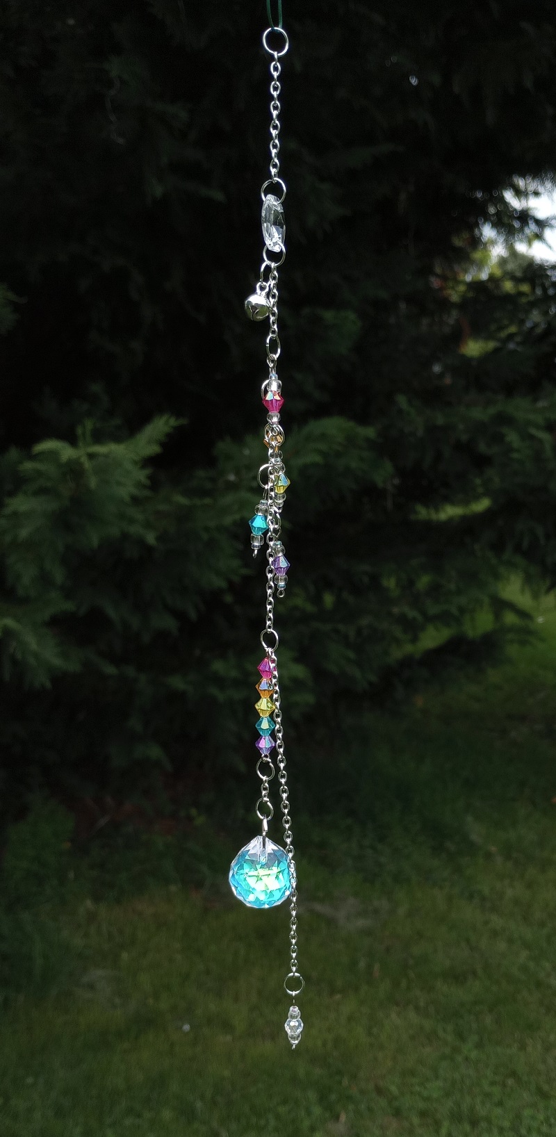 a thin dangle with a round crystal pendulum and rainbow beads