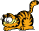 Garfield crouched at the floor with interested eyes.