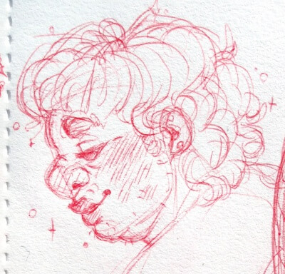 Profile of Mark looking down with a soft smile. His hair is medium length, and he has some stubbles.